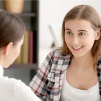 Two girls talking to one another