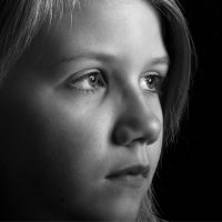 A grayscale photograph of a young person