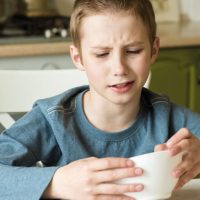 A boy with food representing ARFID