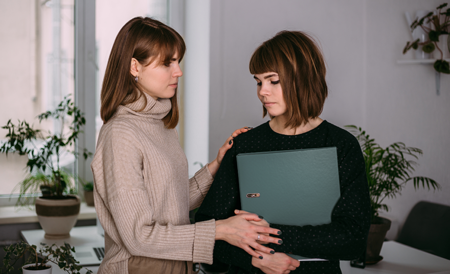 teenage girl comforting her girl friend