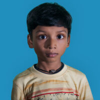 boy looking straight down camera