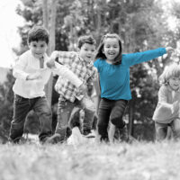 Happy group of kids playing at the park