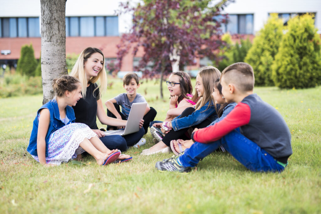 Great,Portrait,Of,School,Pupil,Outside,Classroom,Carrying,Bags,With