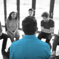 psychologist getting input from teenage focus group