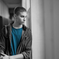 Traumatised teen looking out of window