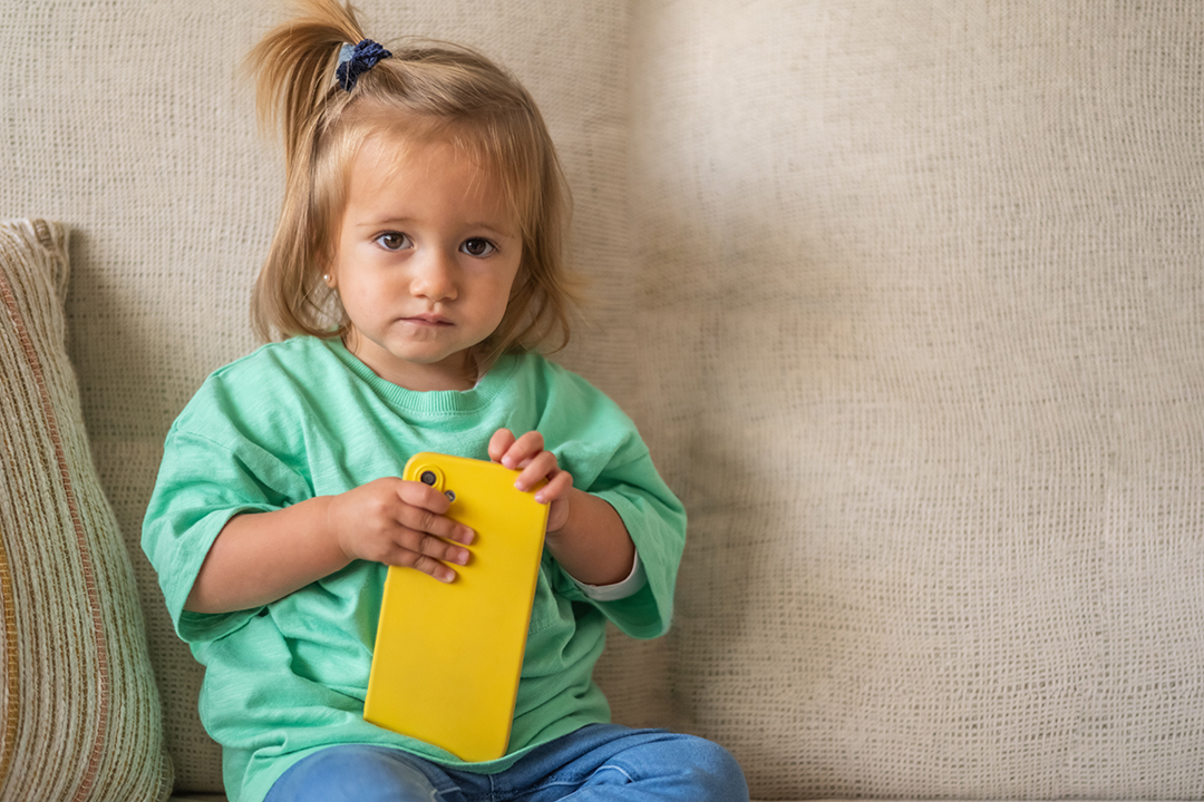 Sweet Baby Interacting With Mobile Device In A Safe, Fun Way, Discovering Modern Technology With Innocence