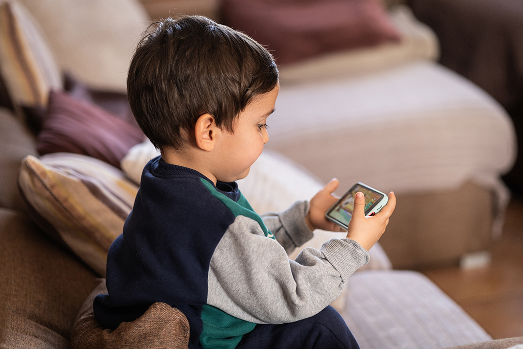 Young Child Engaged with a Mobile Device, Exploring Digital Content