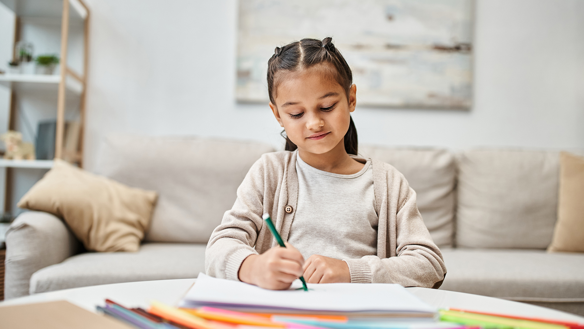 young girl drawing at a desk