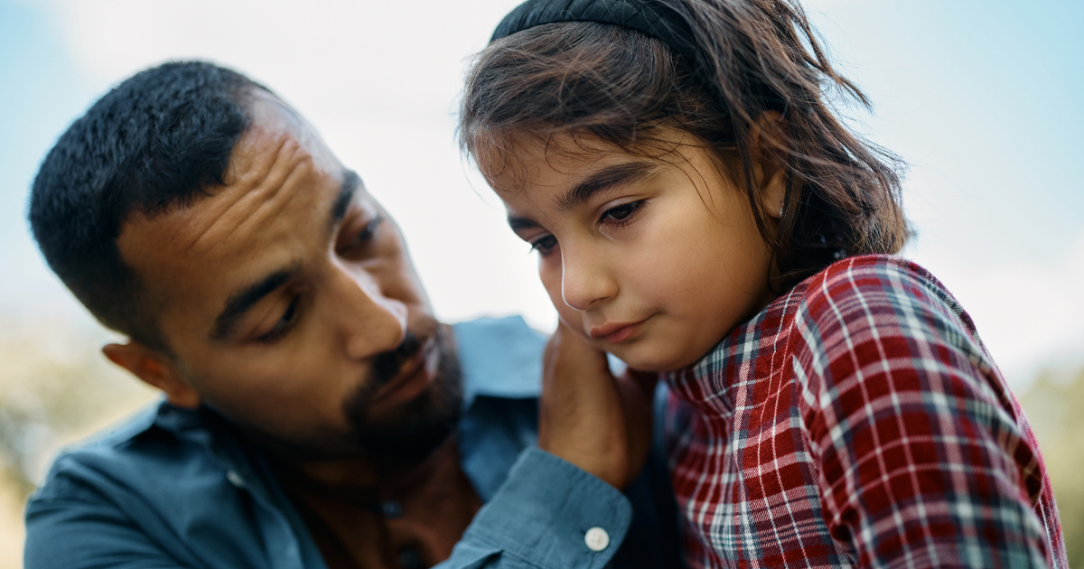father consoling upset daughter