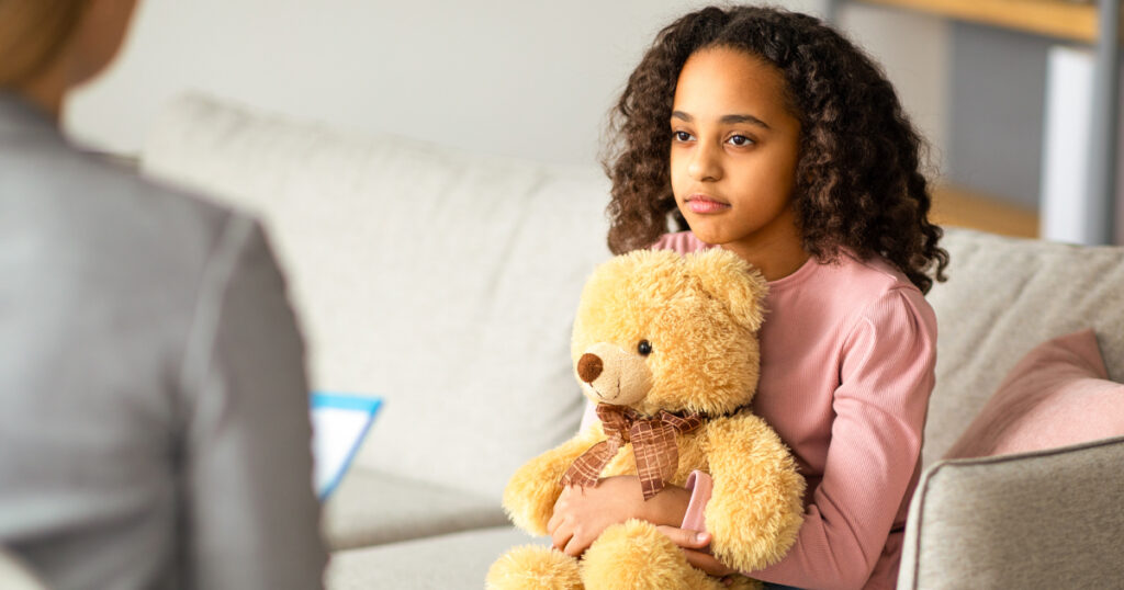 Sad african american girl at psychologist counselor reception, talking about problems in family, teenage troubles