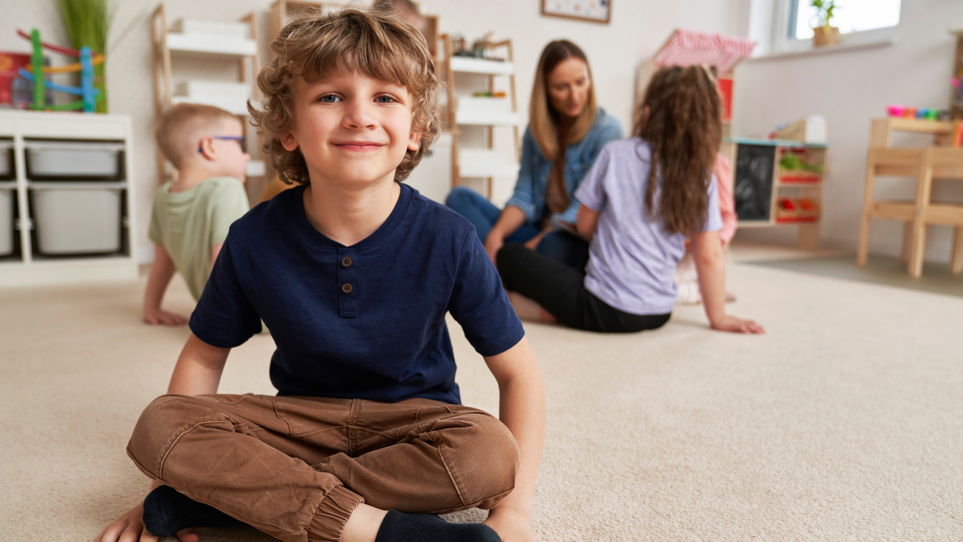 Portrait of preschool boy and children in the background Portrait of preschool boy and children in the background