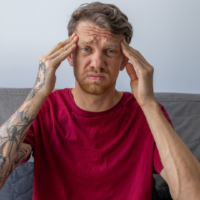 Man holding his head representing adhd training for professionals