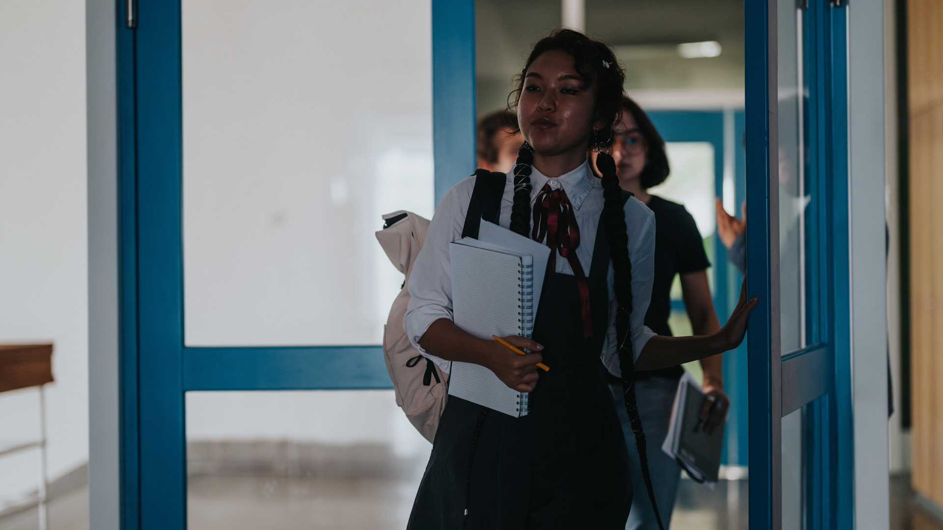 Photo of a student walking down a secondary school corridor Photo of a student walking down a secondary school corridor